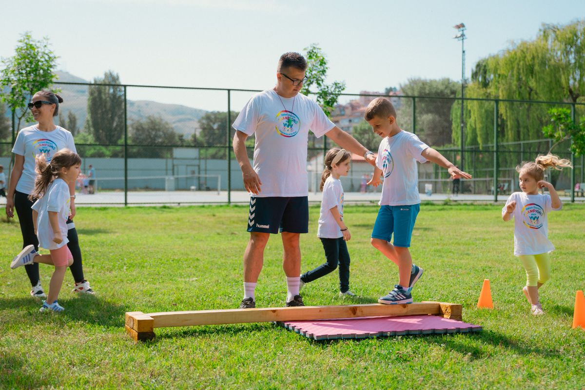 Kids guided by instructors at a park balance on a beam for fun and exercise. - Photo by Aleksandar Andreev on Pexels